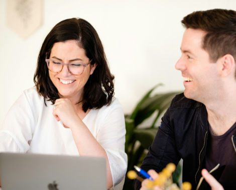 Apprenticeship employers have discussion while working on a laptop